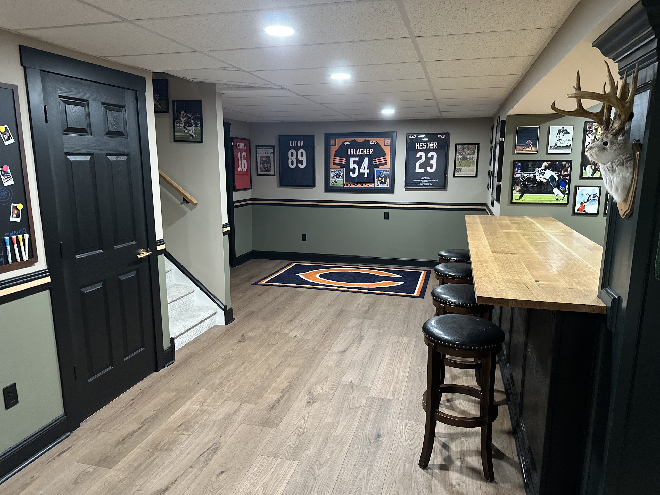 Finished sports basement with custom bar, coordinated trim and seating