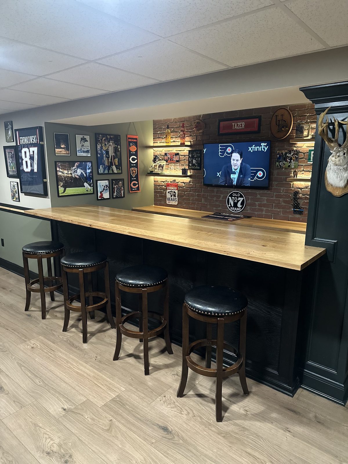 Angled view of custom basement bar seating area