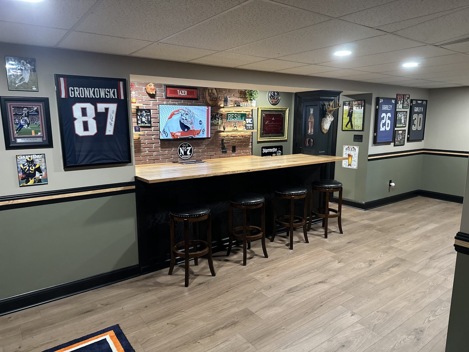 Wide view of basement bar and sports basement